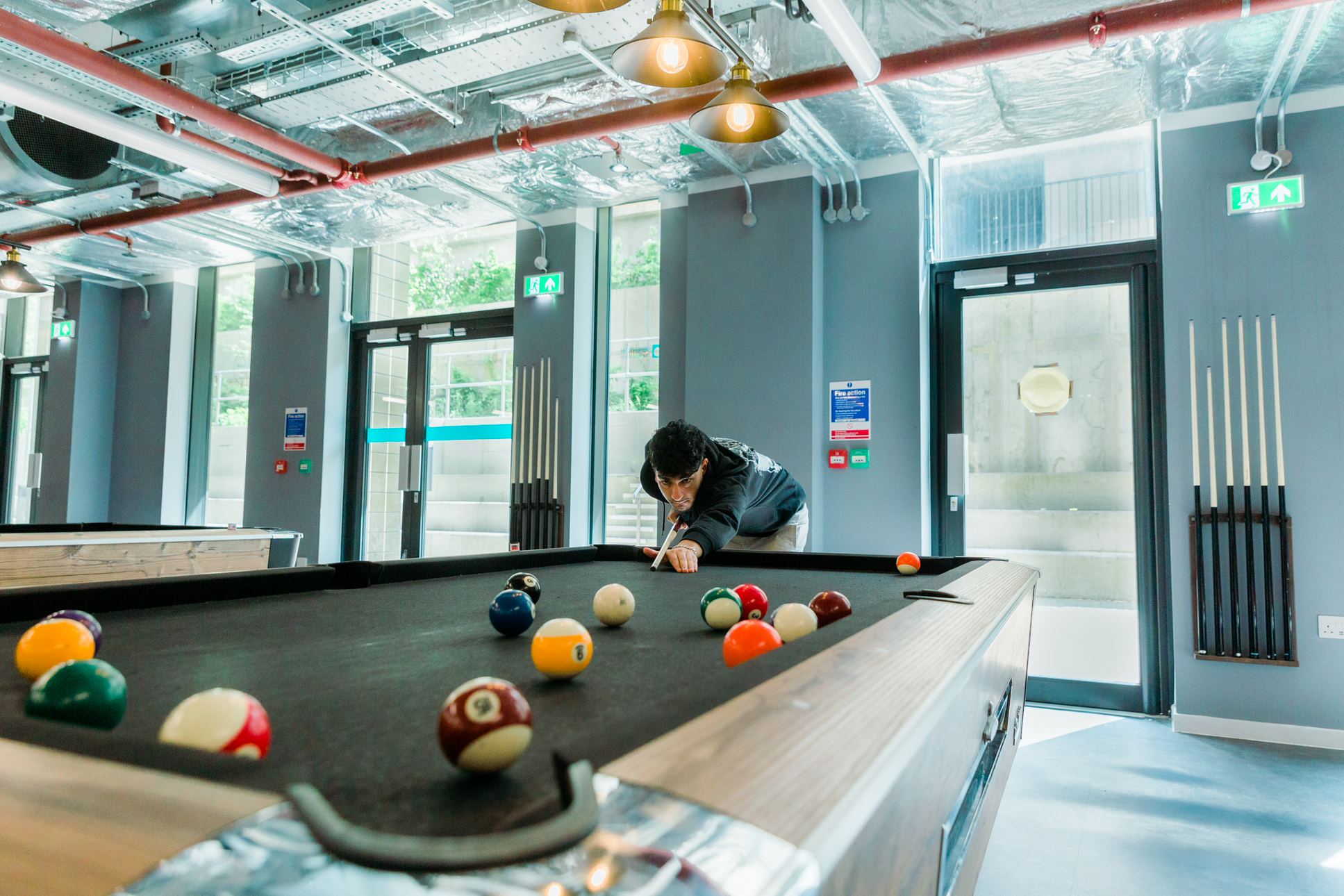 Photo of a student playing pool in The Venue